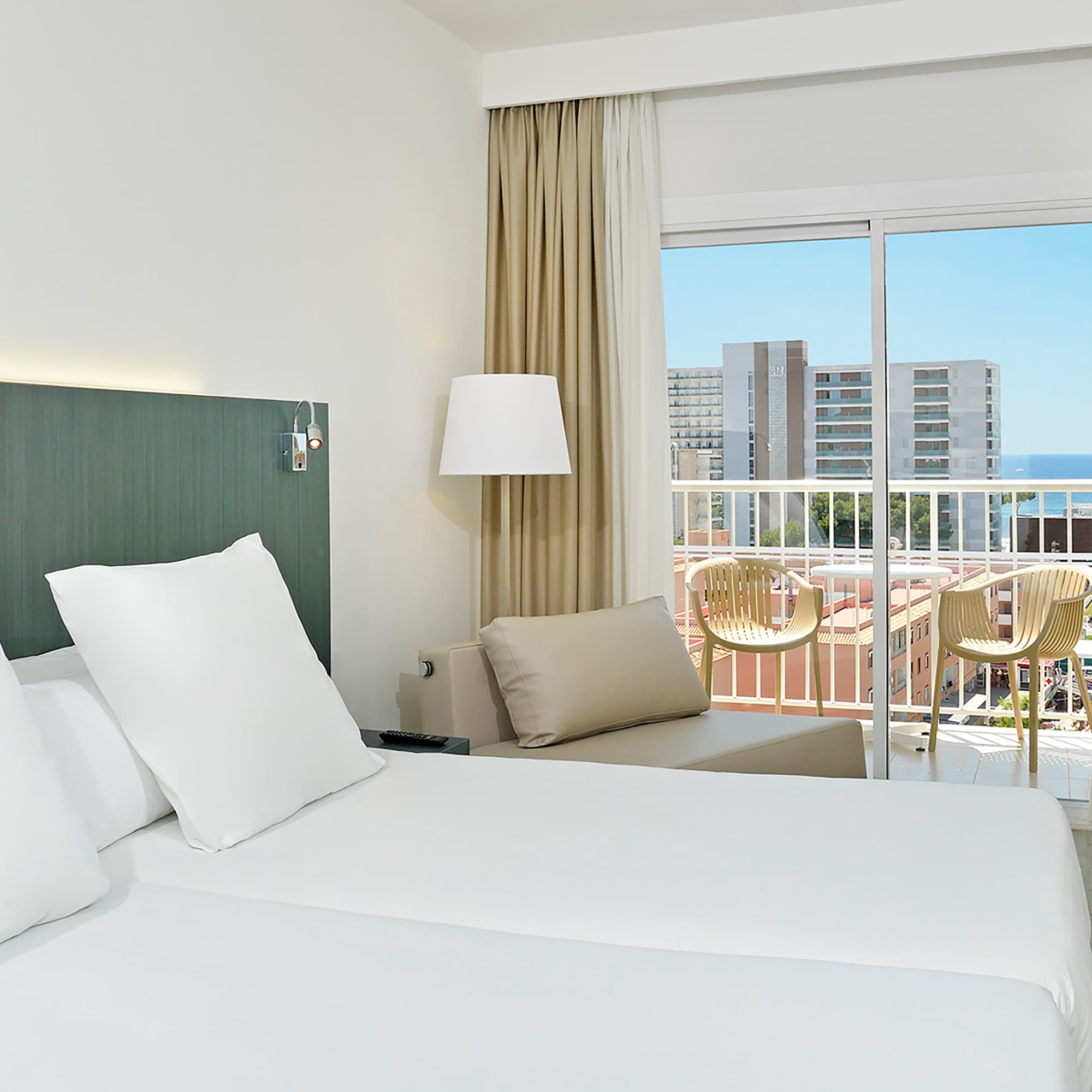 a hotel room with a balcony and a large bed