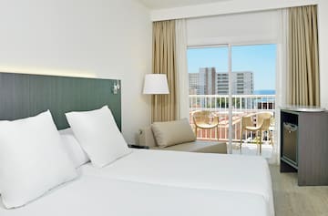 a hotel room with a balcony and a large bed
