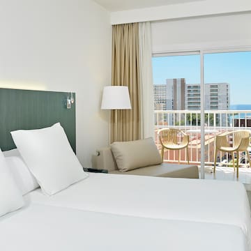 a hotel room with a balcony and a large bed