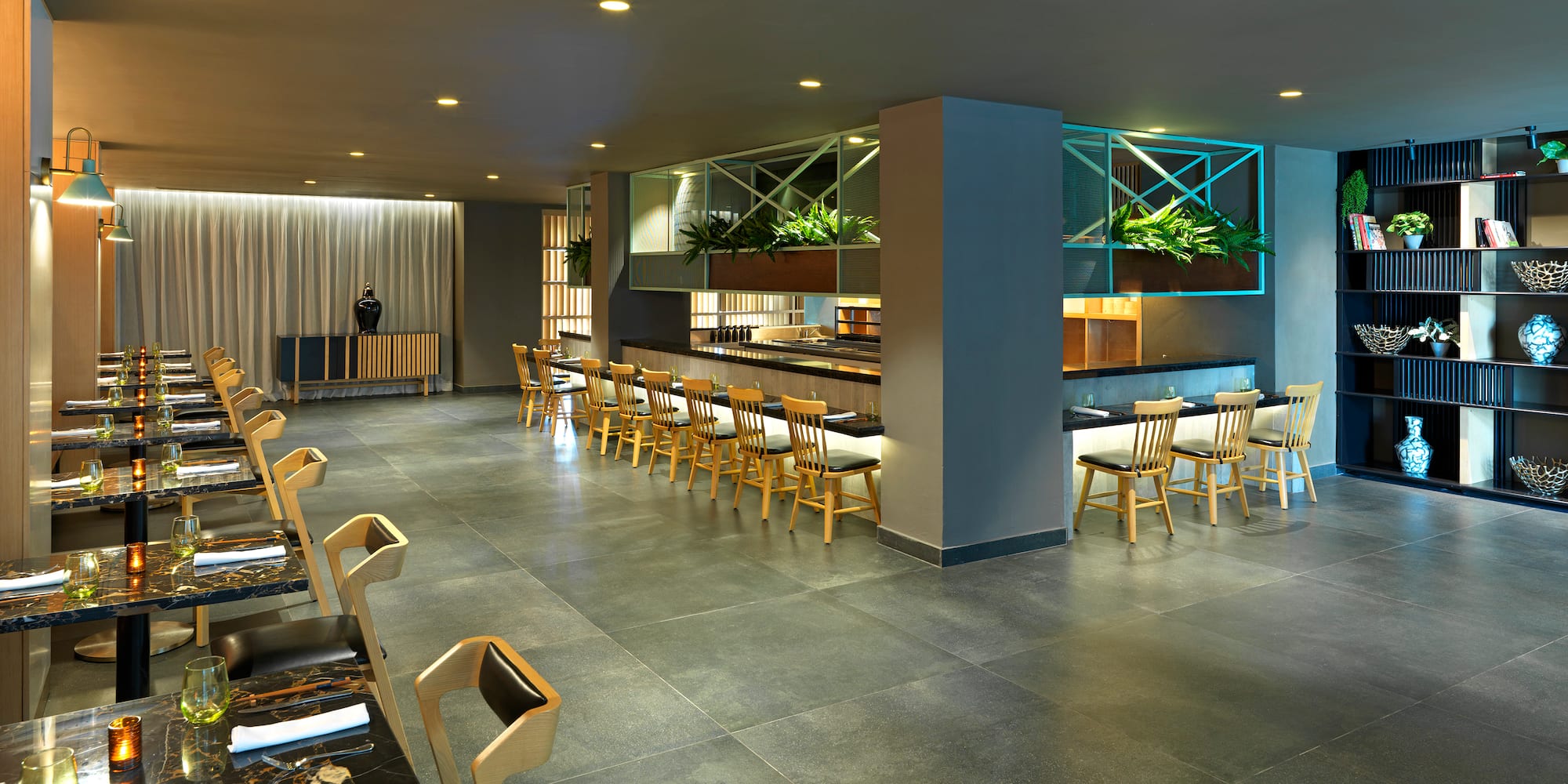 a room with a bar and chairs