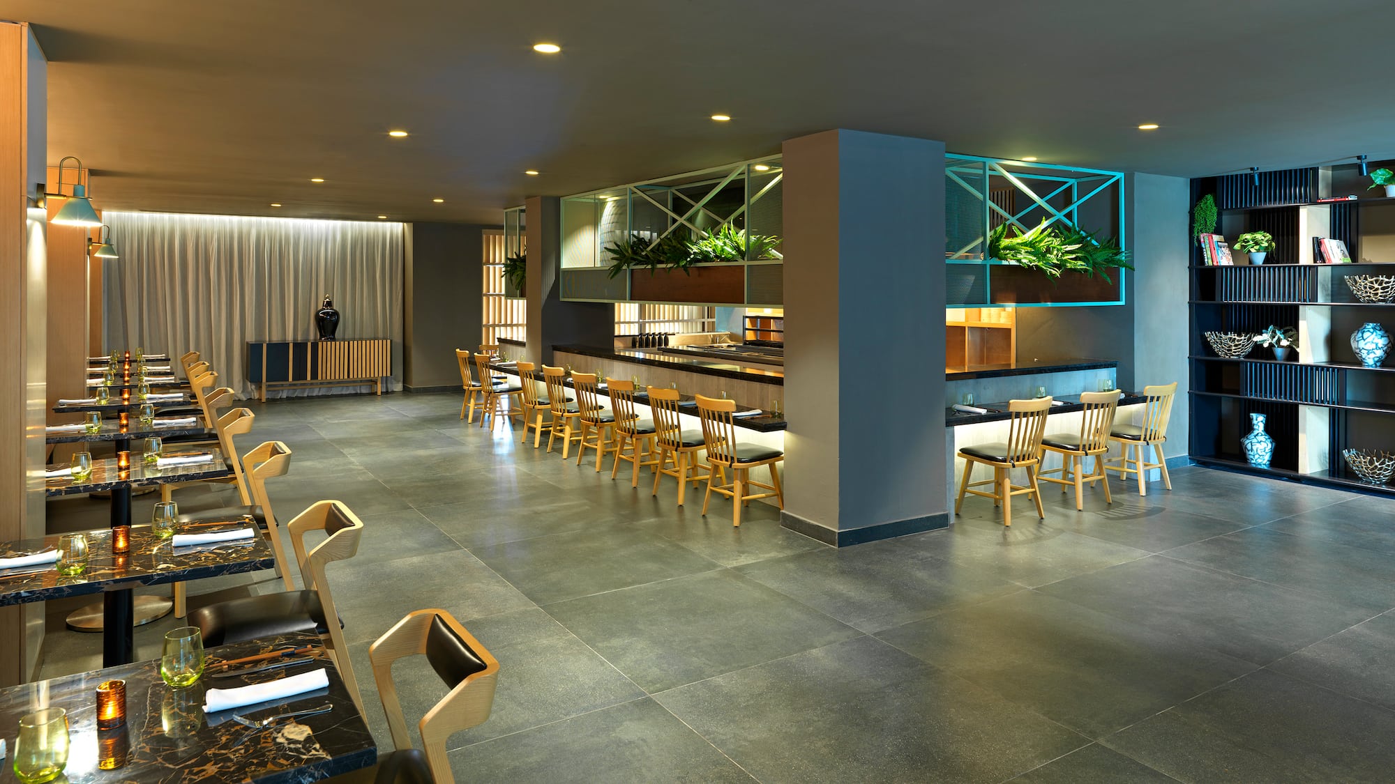 a room with a bar and chairs