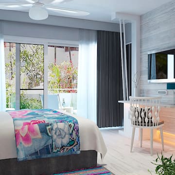 a bedroom with a bed and a television