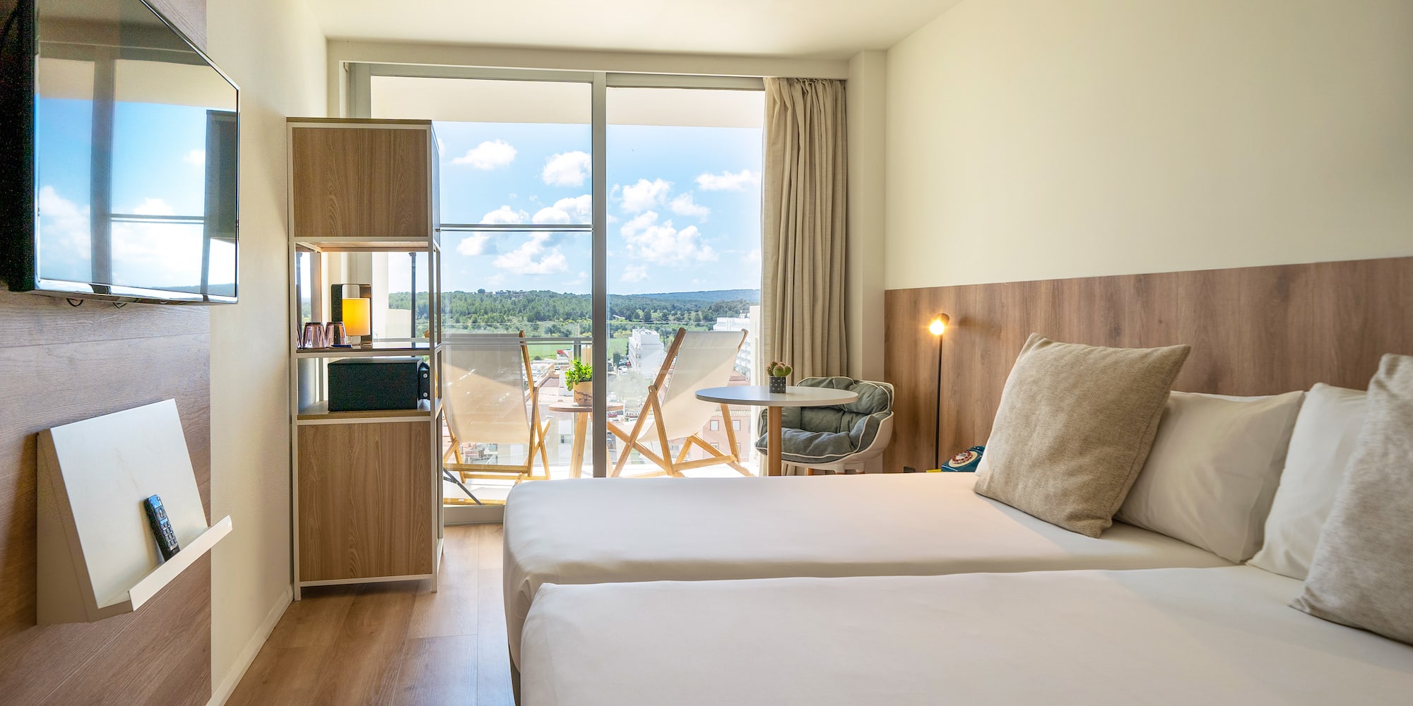 a room with two beds and a glass door