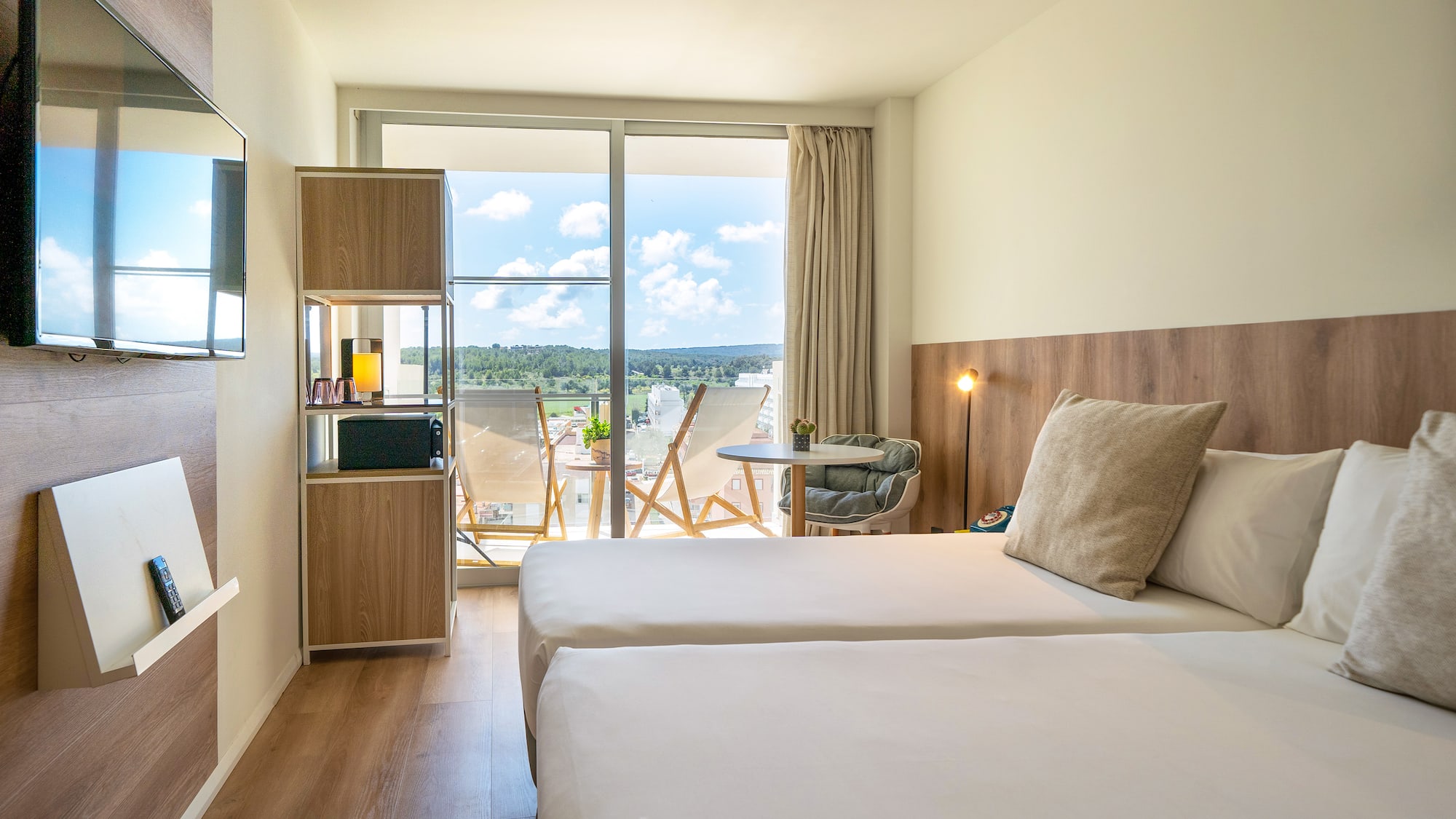 a room with two beds and a glass door