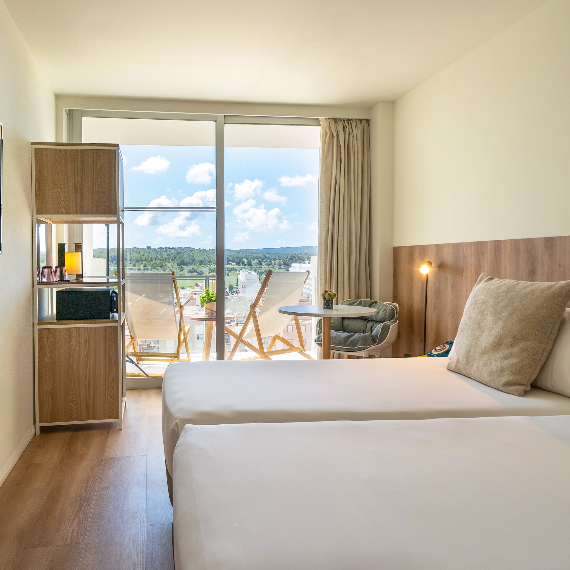 a room with two beds and a glass door