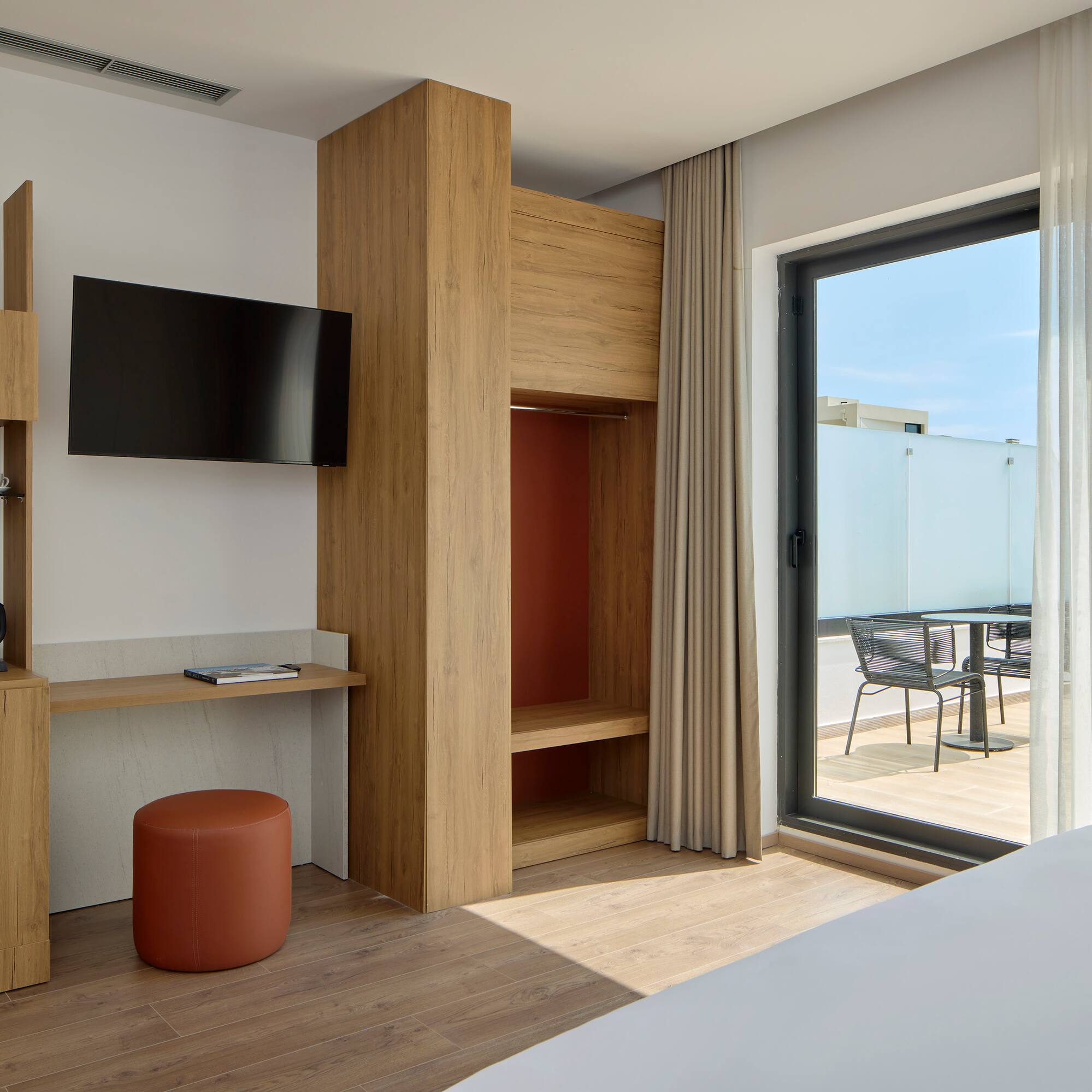 a room with a bed and a television