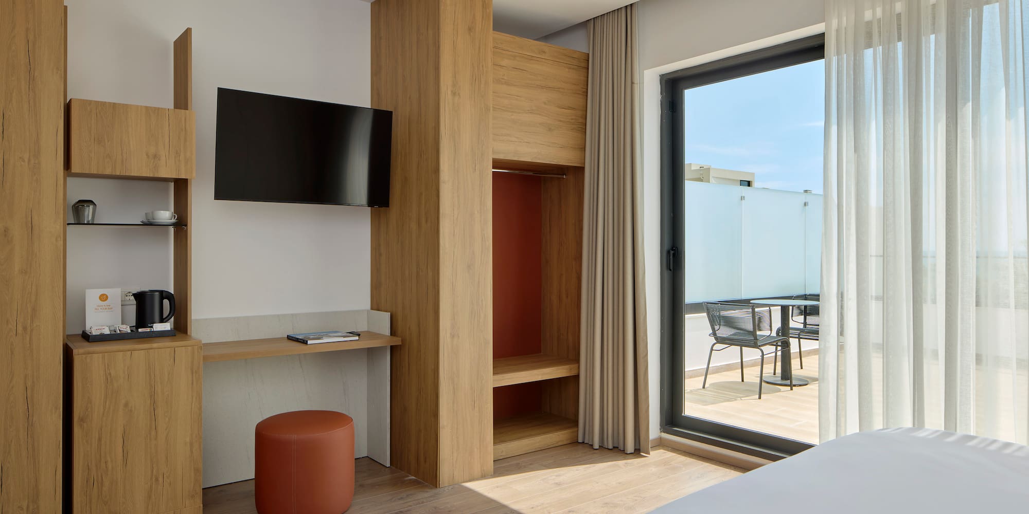 a room with a bed and a television