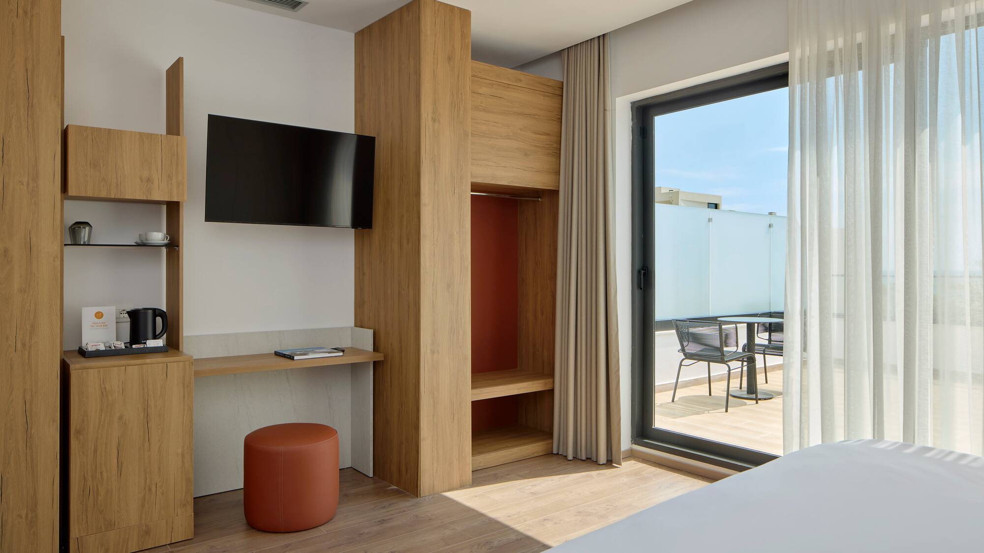 a room with a bed and a television