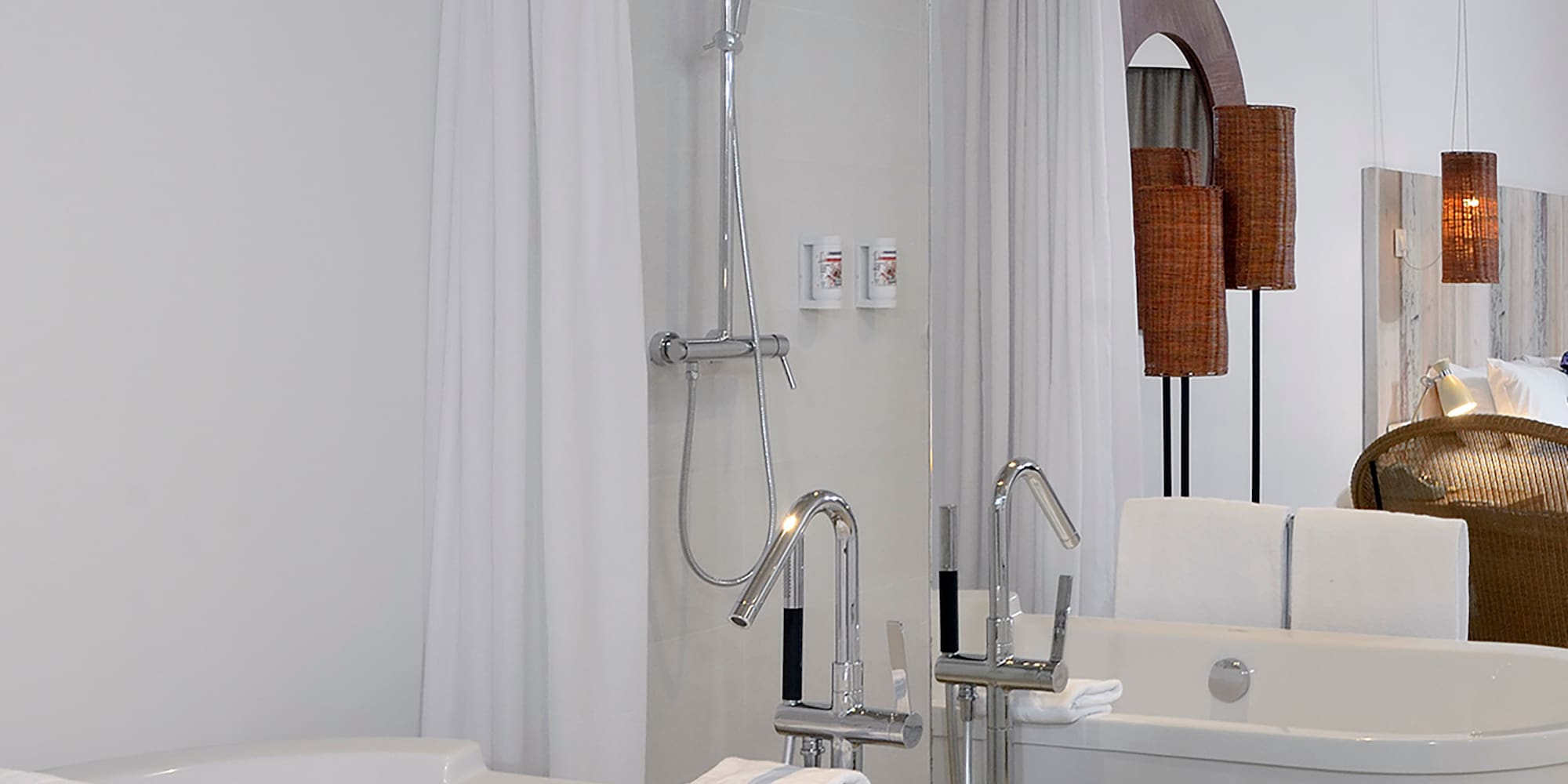 a bathroom with bathtubs and shower