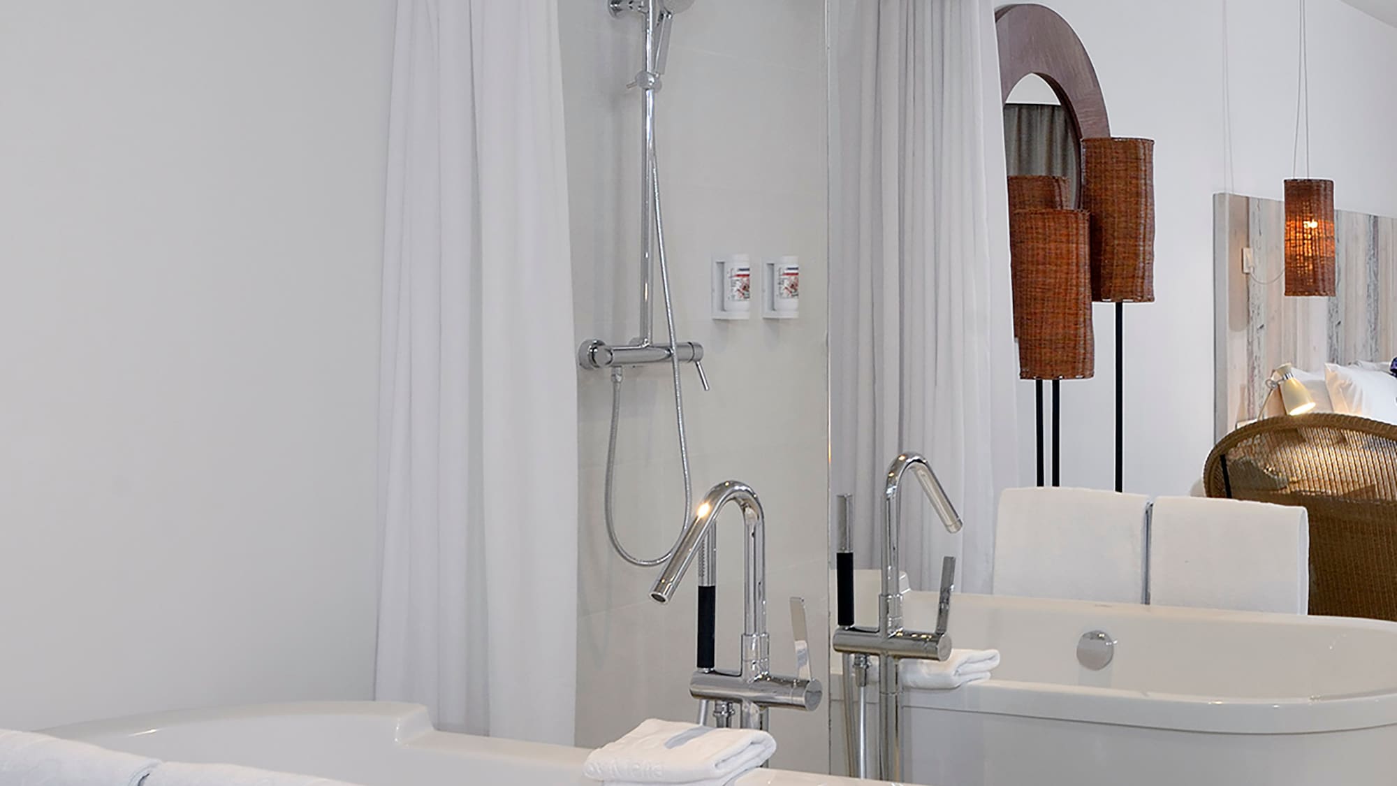 a bathroom with bathtubs and shower