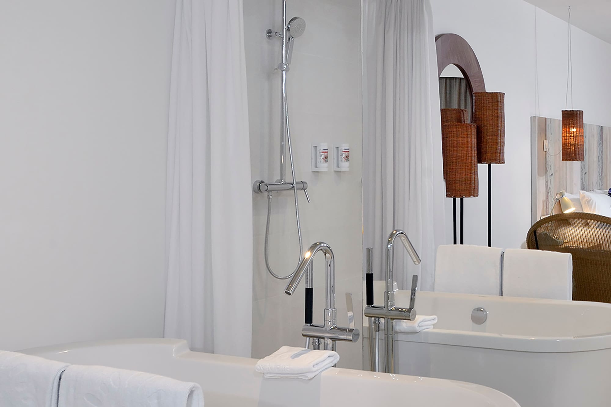a bathroom with bathtubs and shower