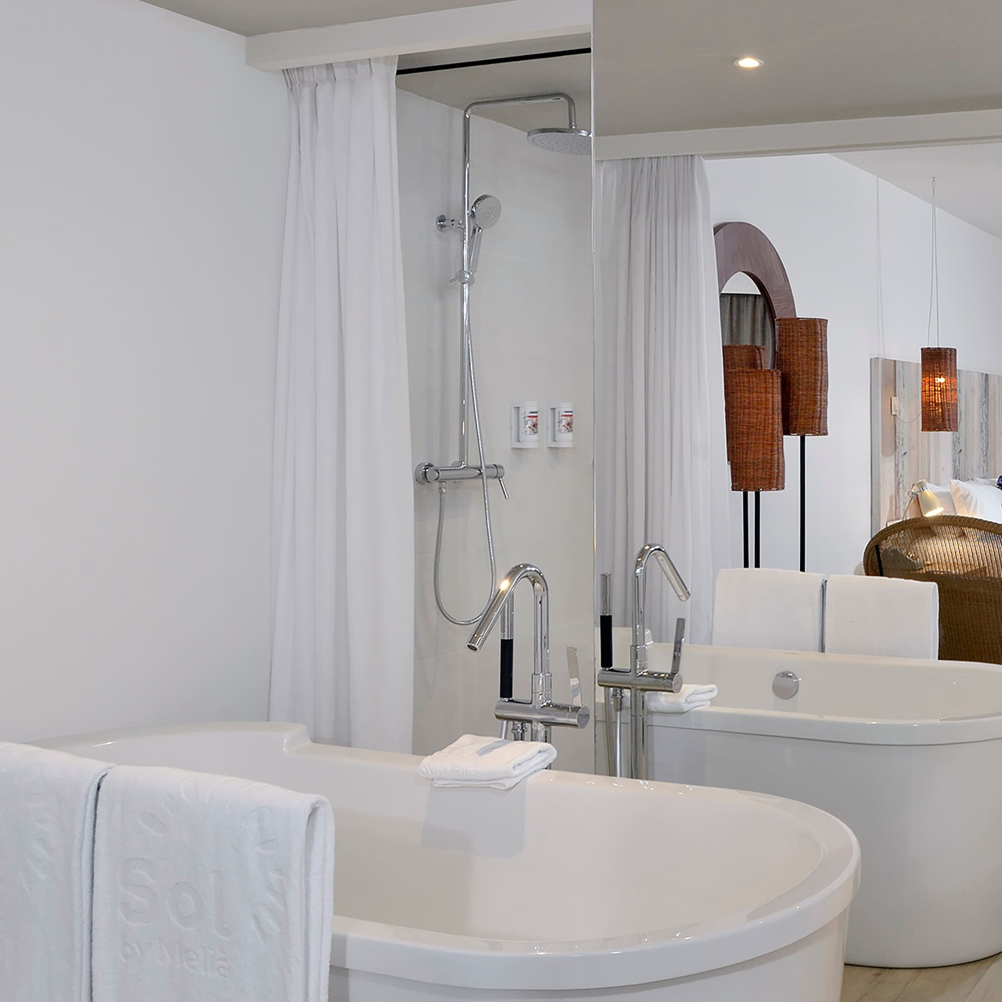 a bathroom with bathtubs and shower