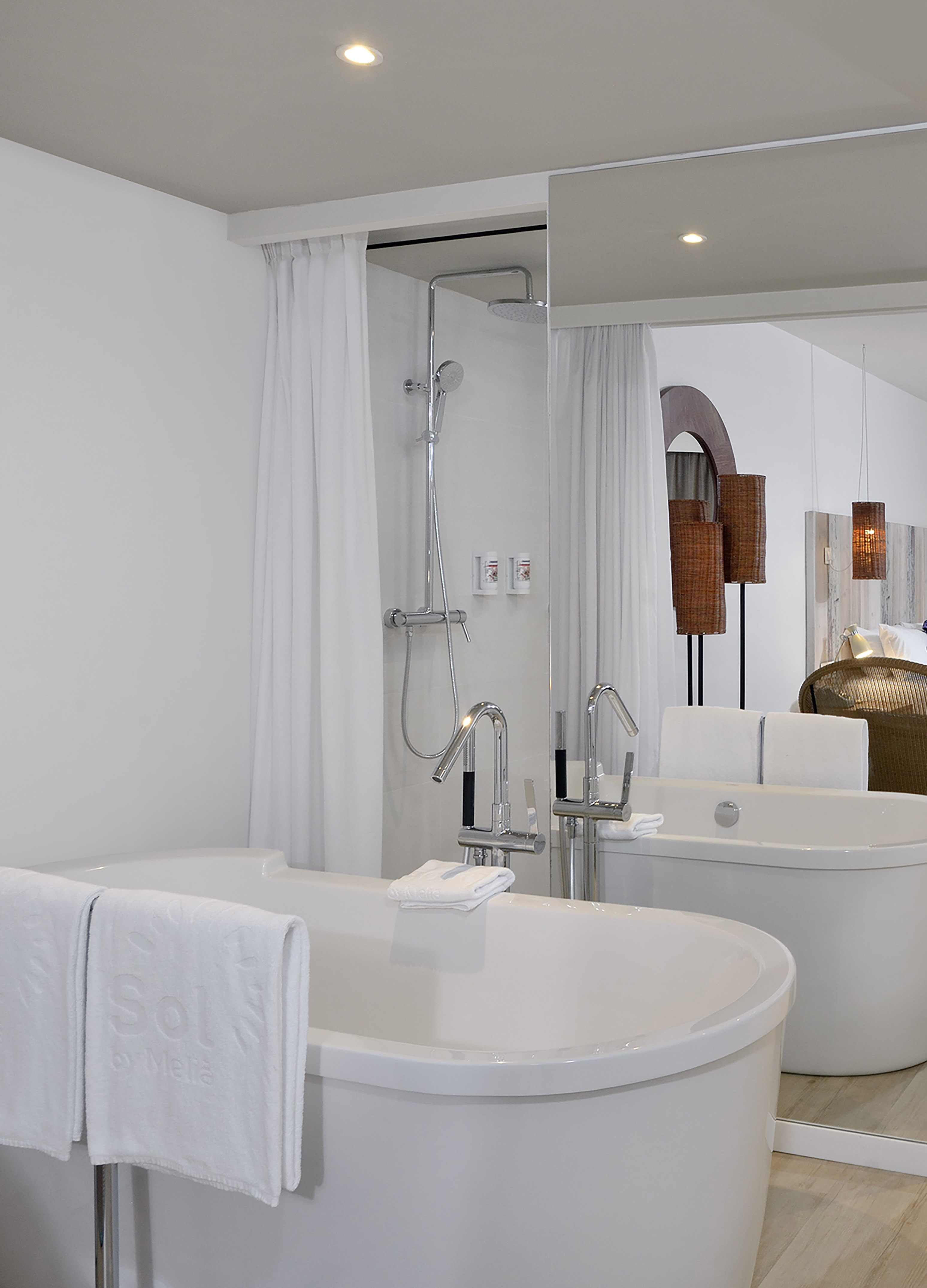 a bathroom with bathtubs and shower