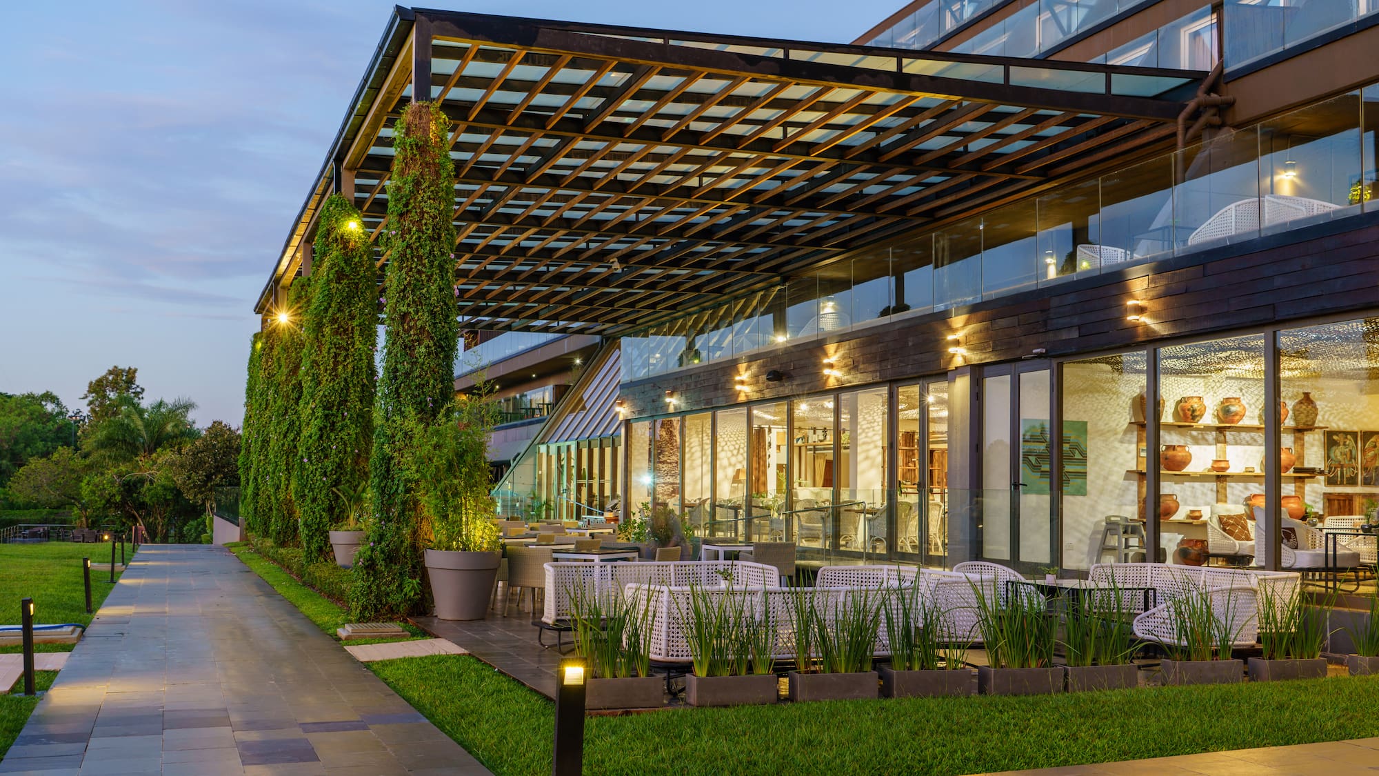 a building with a covered patio and trees