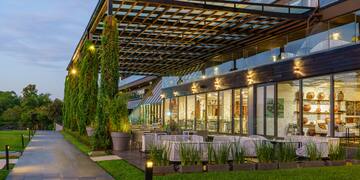 a building with a covered patio and trees