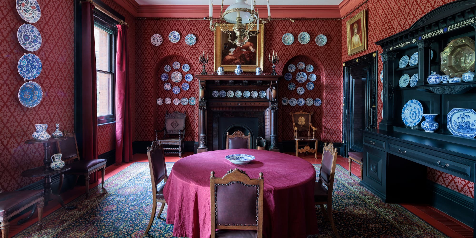 a room with a red table and chairs