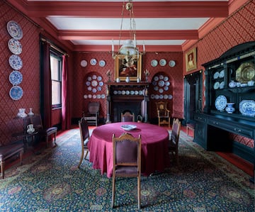 a room with a red table and chairs