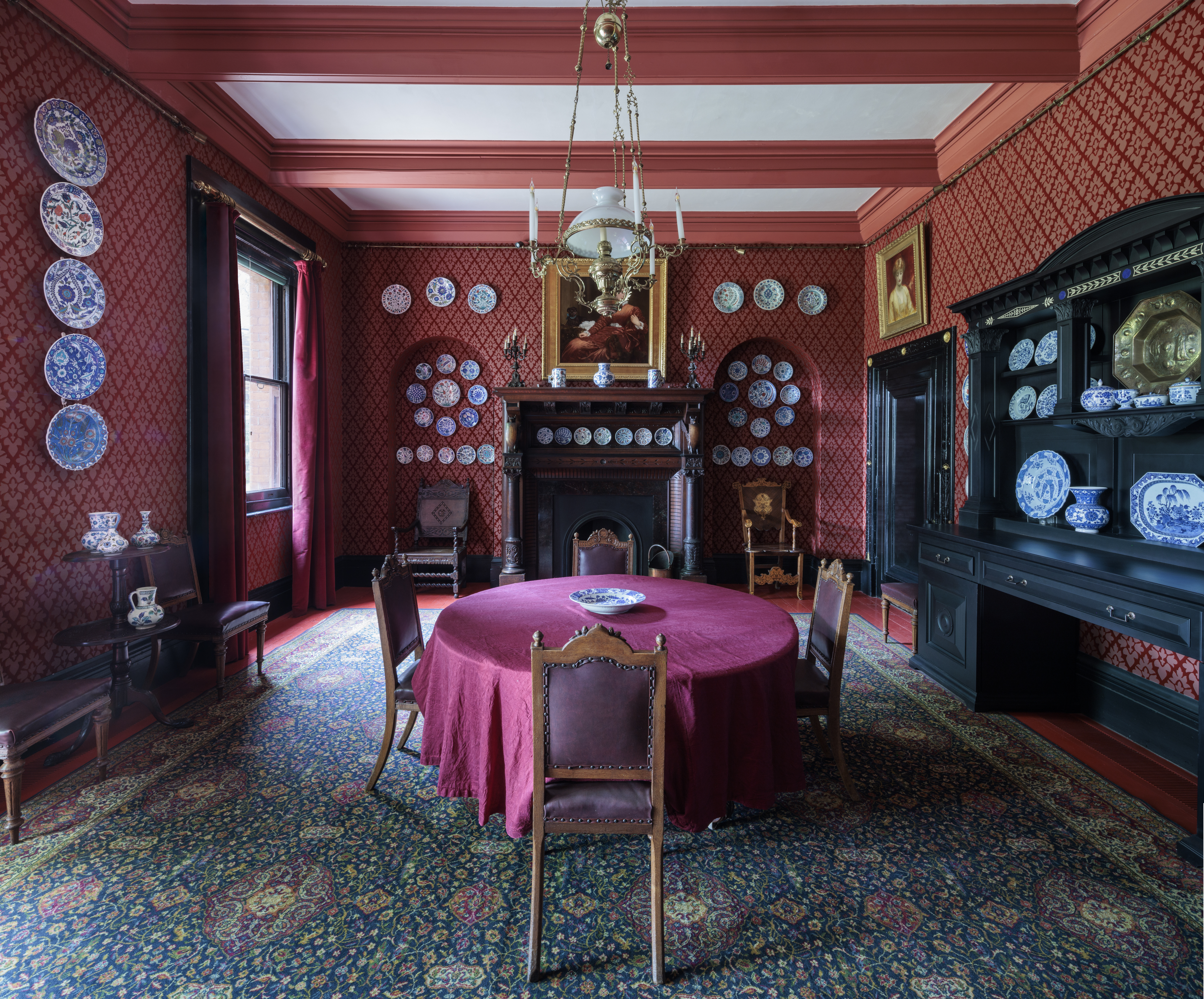 a room with a red table and chairs