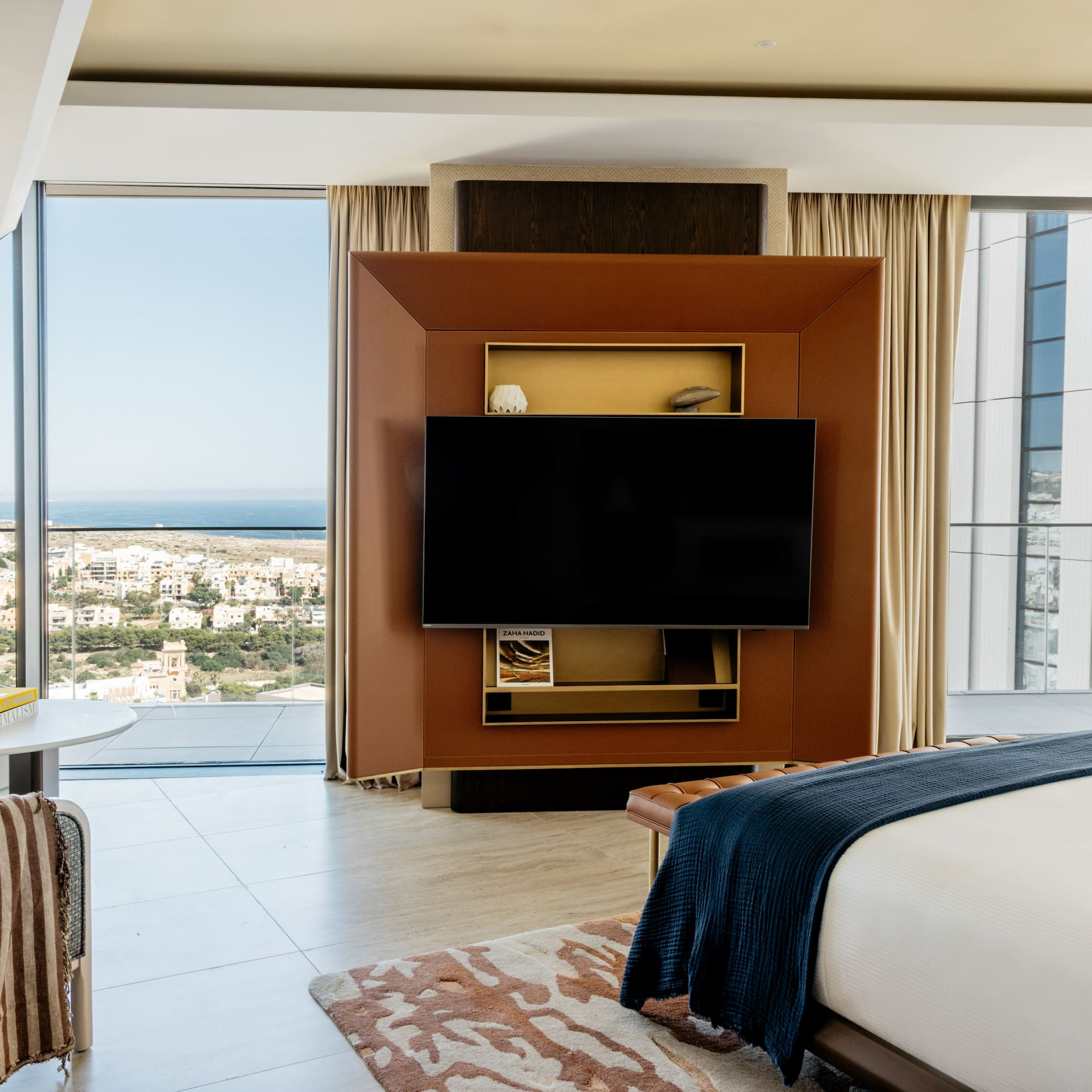 a room with a television and a view of the city