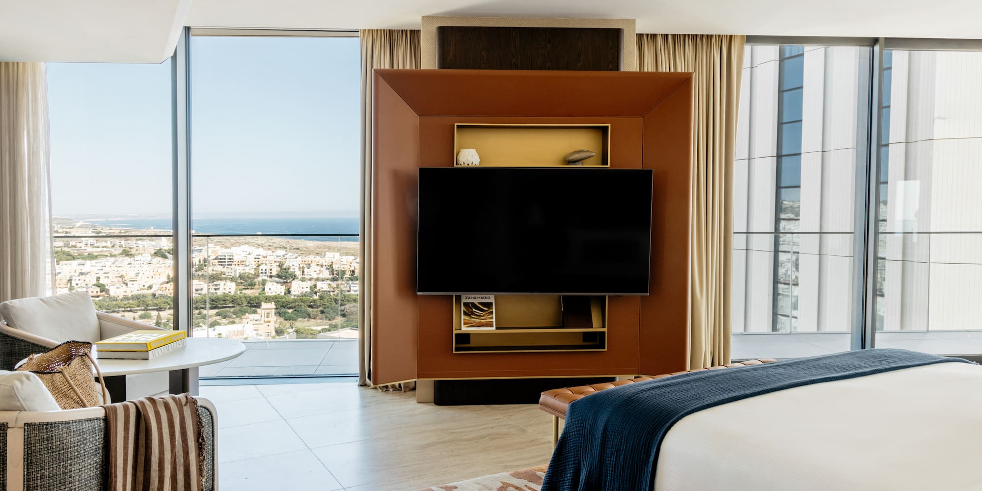 a room with a television and a view of the city