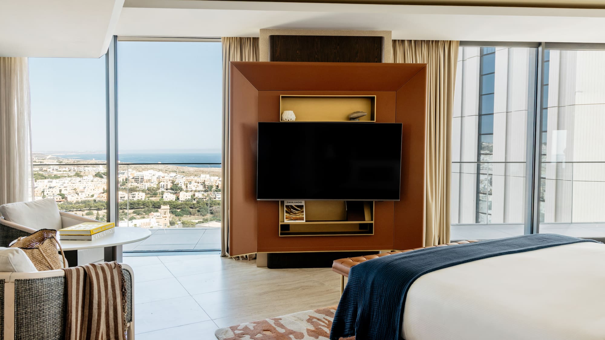 a room with a television and a view of the city