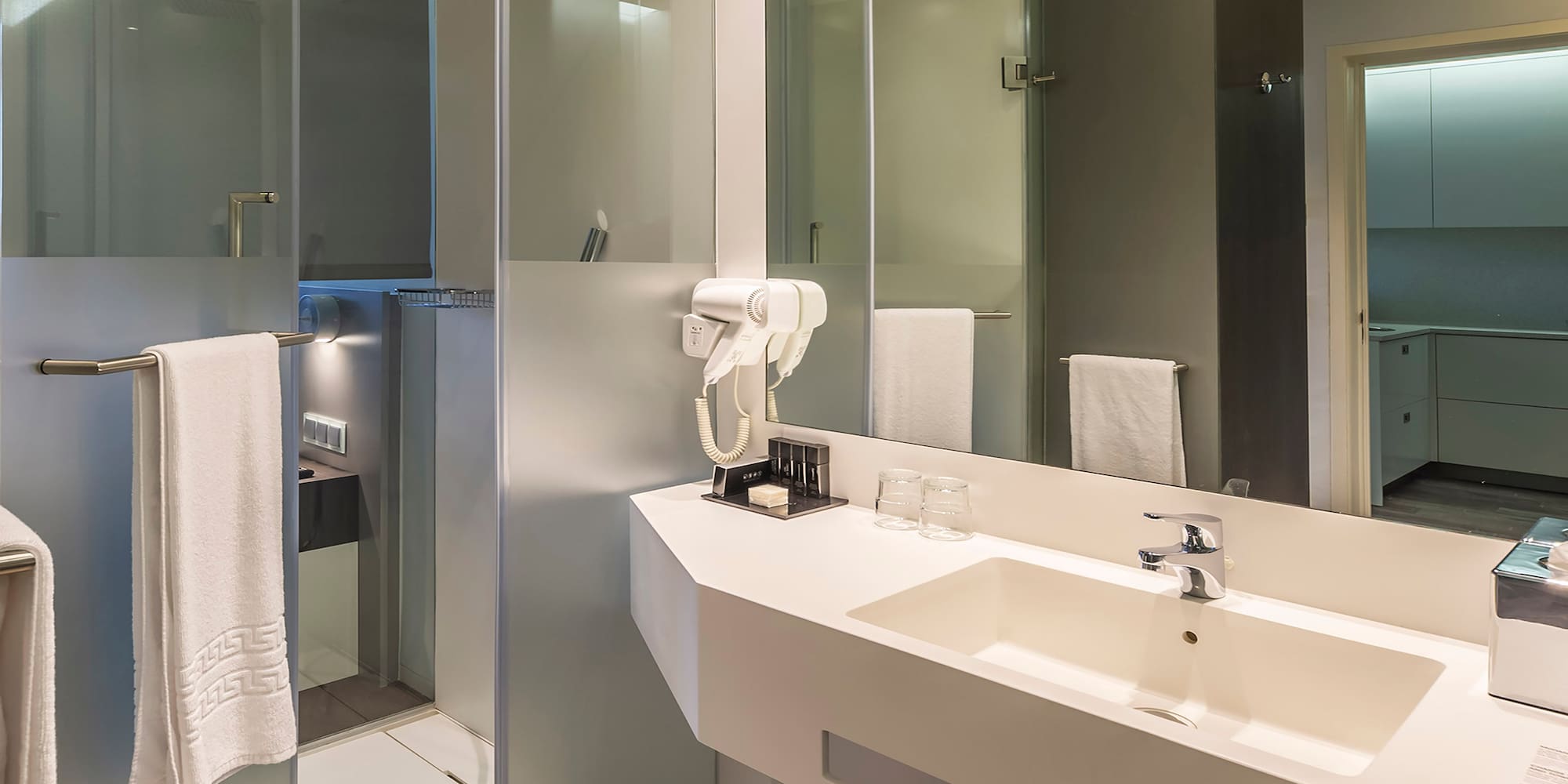 a bathroom with a shower and sink