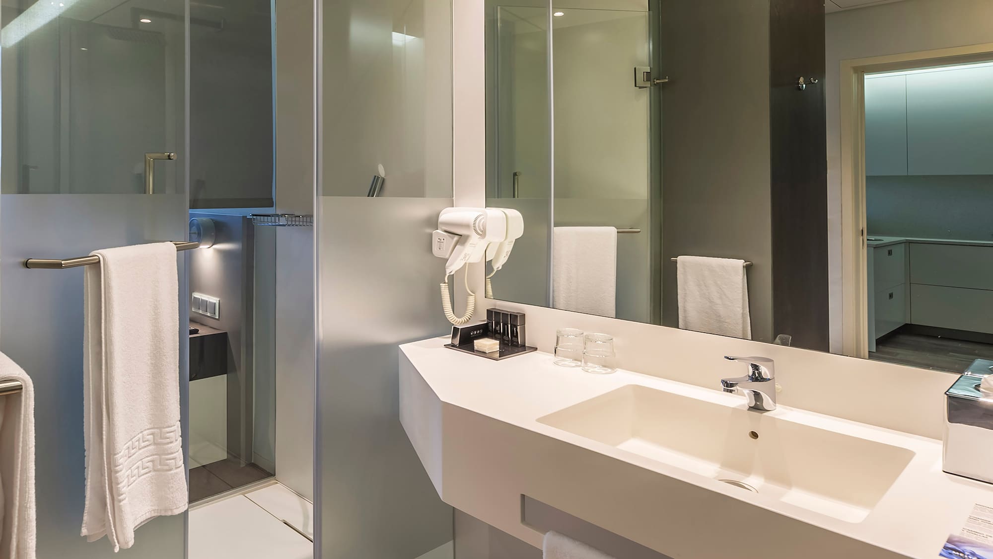 a bathroom with a shower and sink