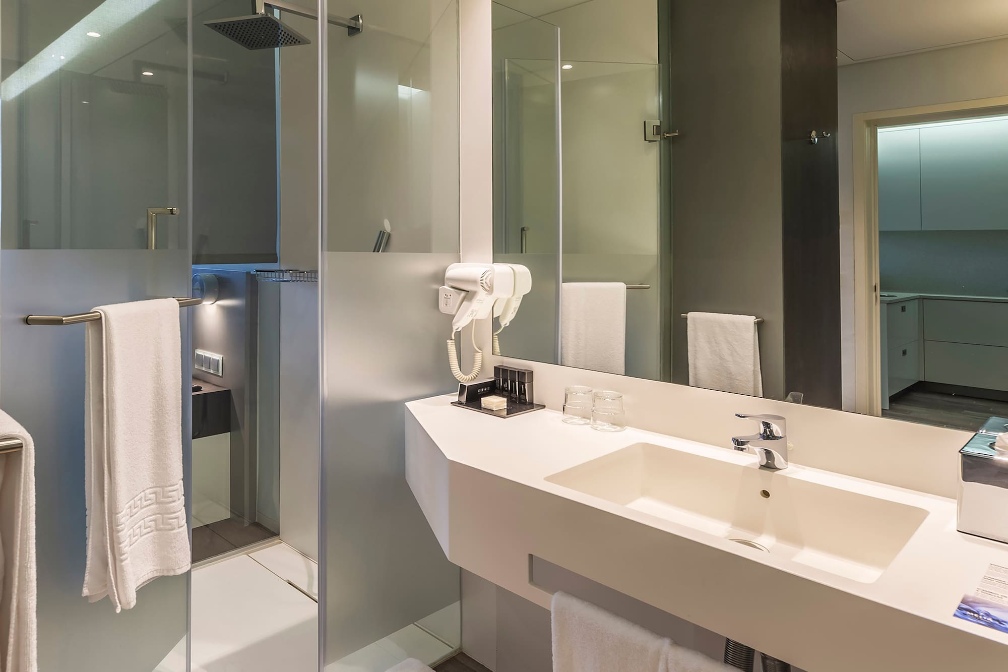 a bathroom with a shower and sink