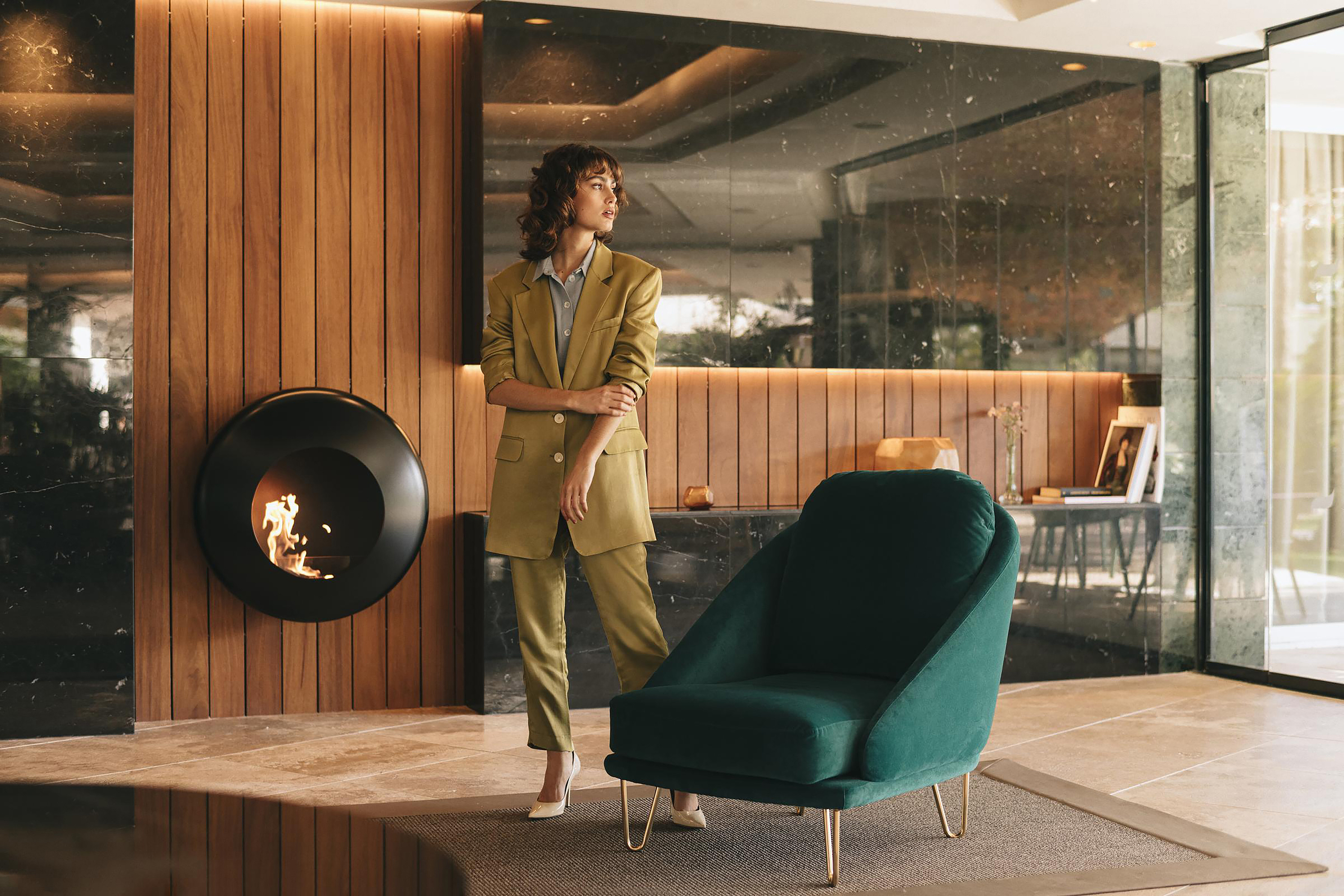 a woman standing next to a chair