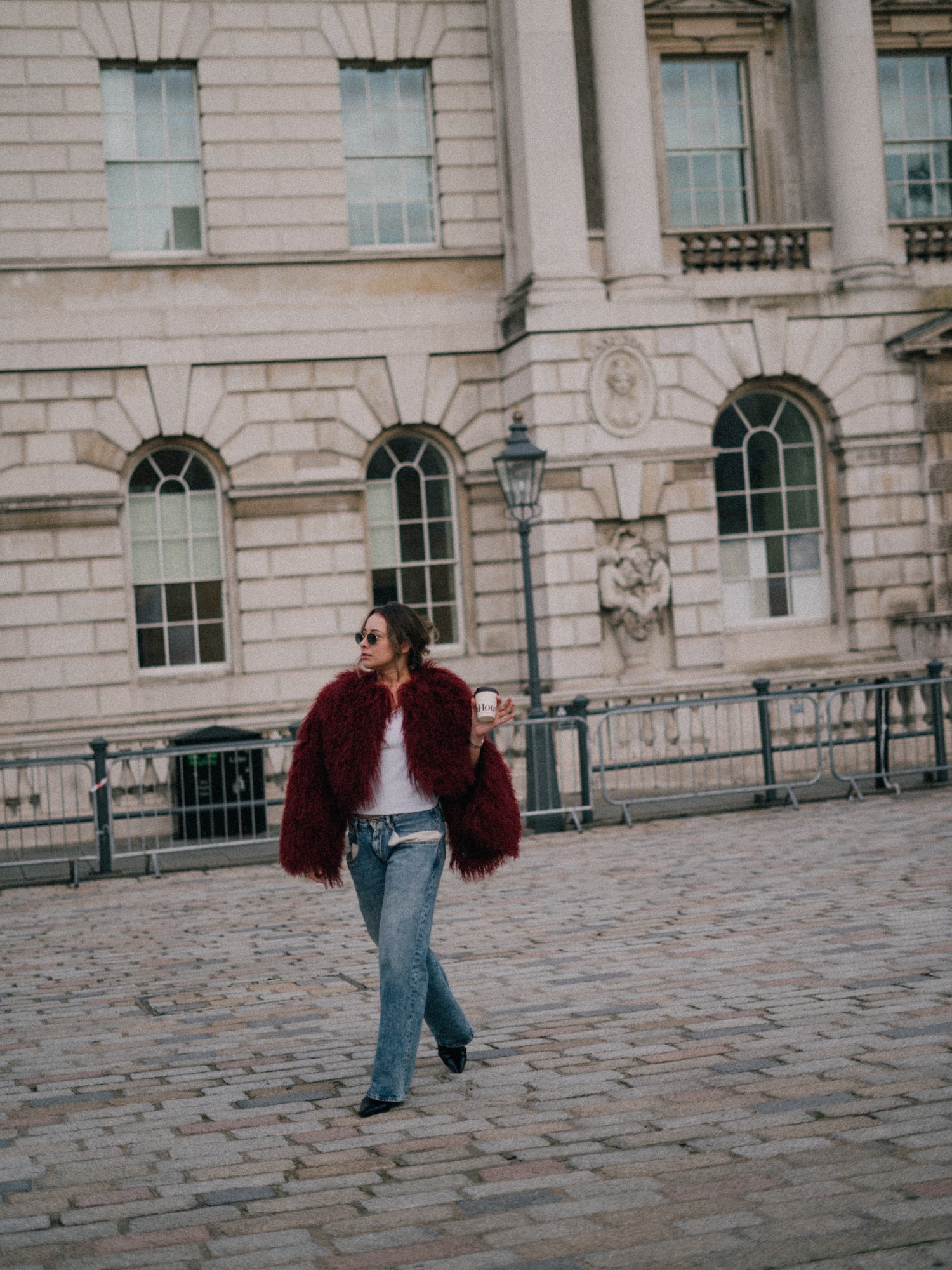 a woman walking on a brick walkway