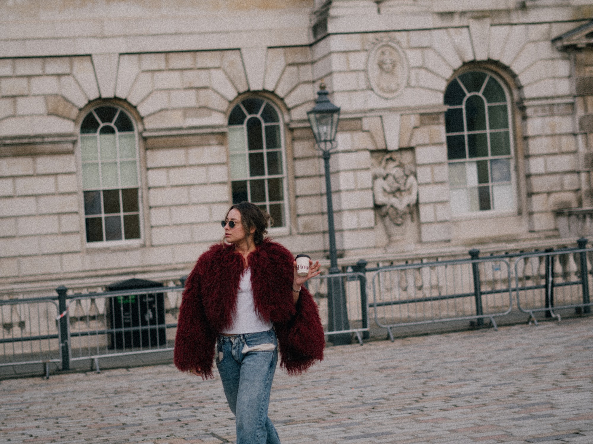 a woman walking on a brick walkway