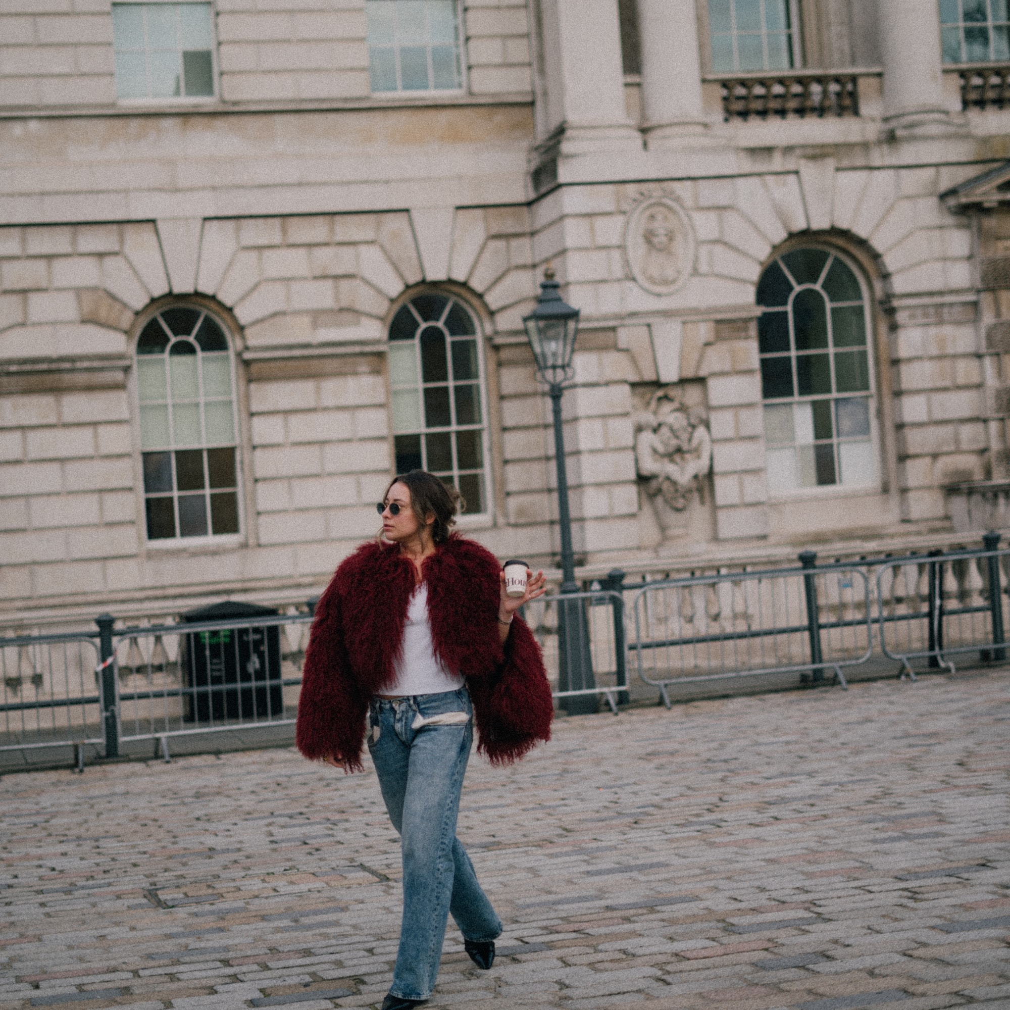 a woman walking on a brick walkway