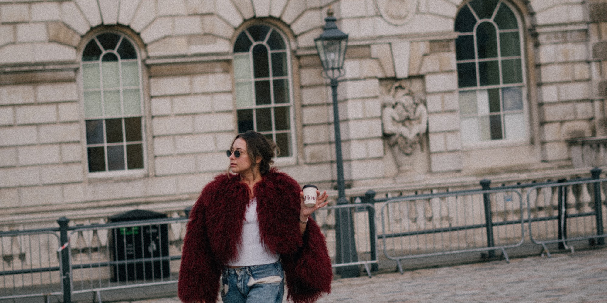 a woman walking on a brick walkway
