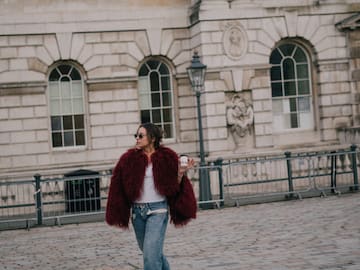 a woman walking on a brick walkway