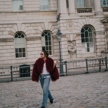 a woman walking on a brick walkway