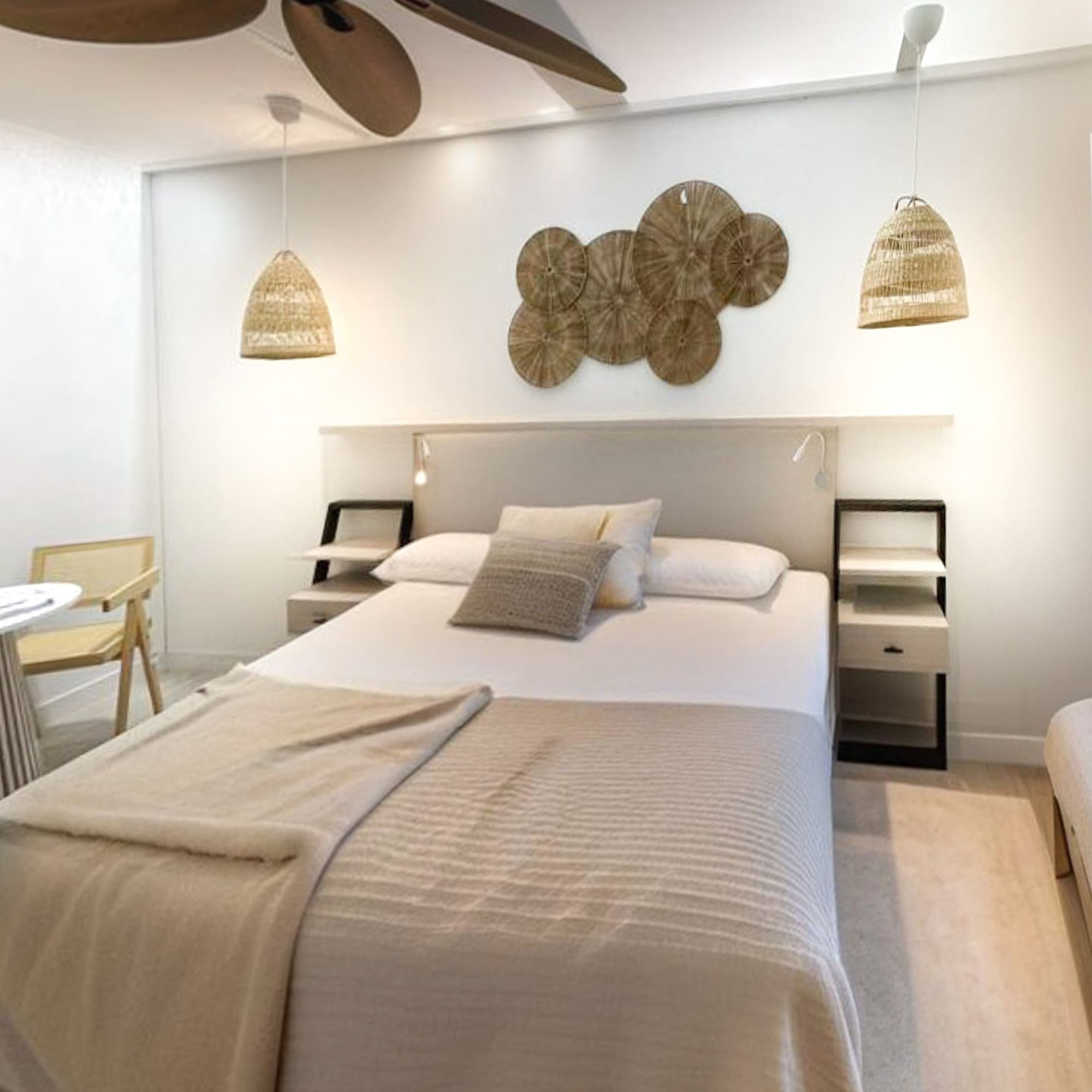 a bedroom with a bed and a fan