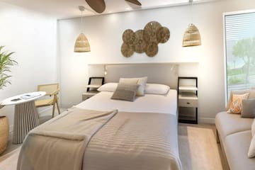 a bedroom with a bed and a fan