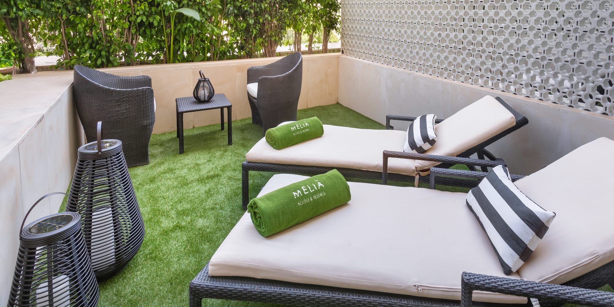 a patio with chairs and a table