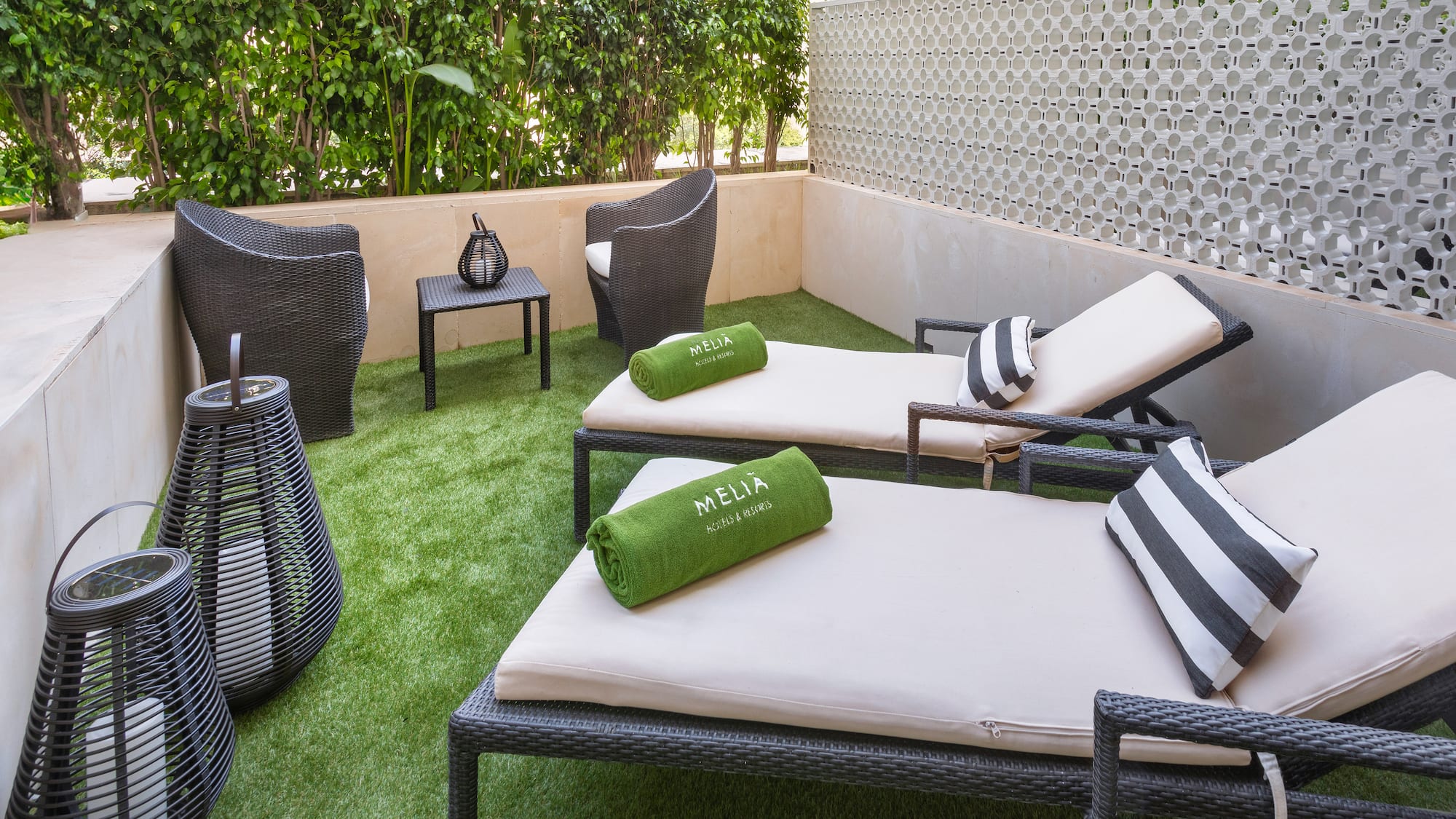 a patio with chairs and a table