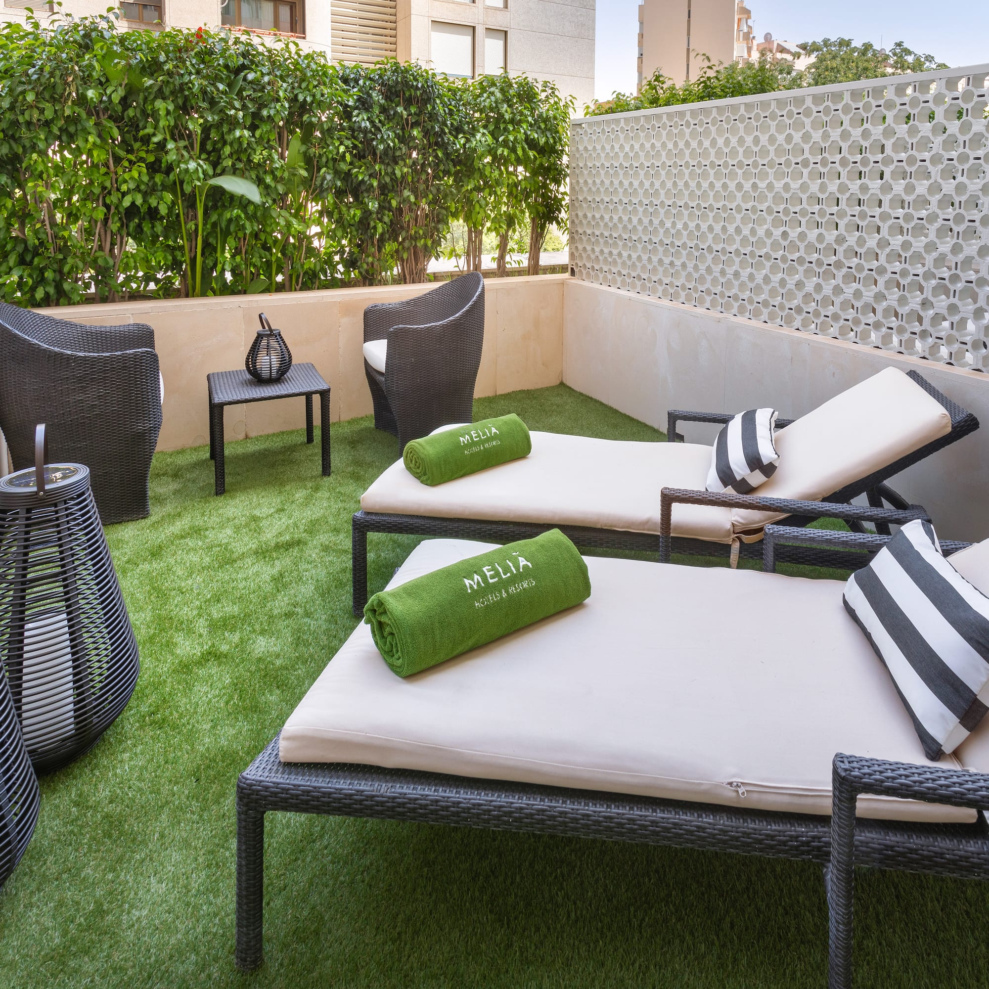 a patio with chairs and a table