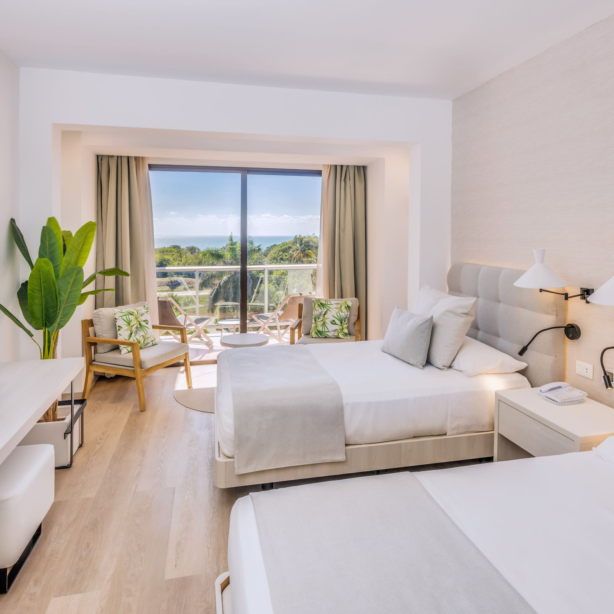 a room with two beds and a glass door