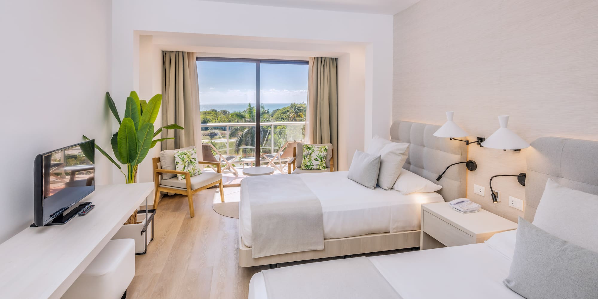 a room with two beds and a glass door