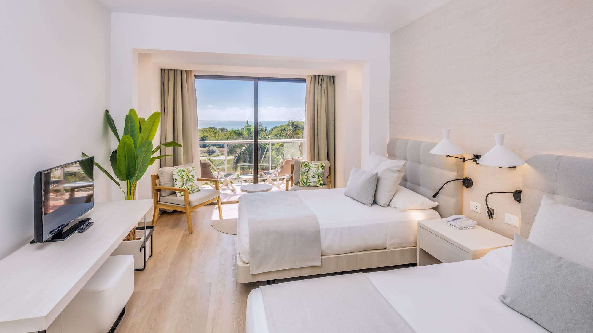 a room with two beds and a glass door