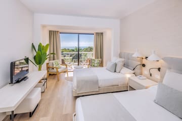 a room with two beds and a glass door