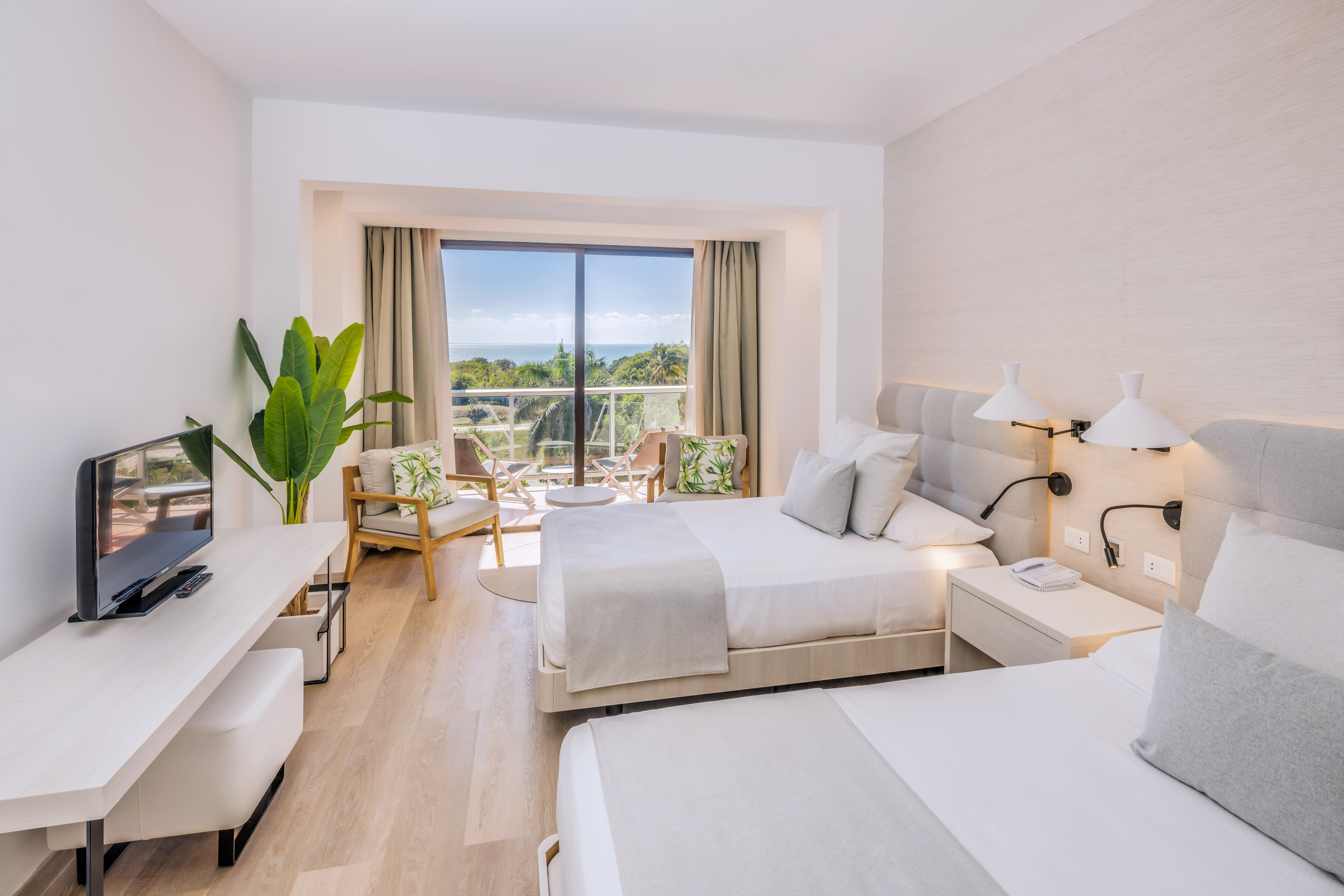 a room with two beds and a glass door