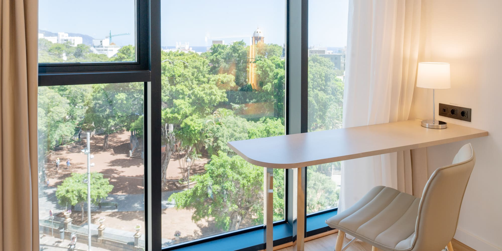 a desk and chair next to a window
