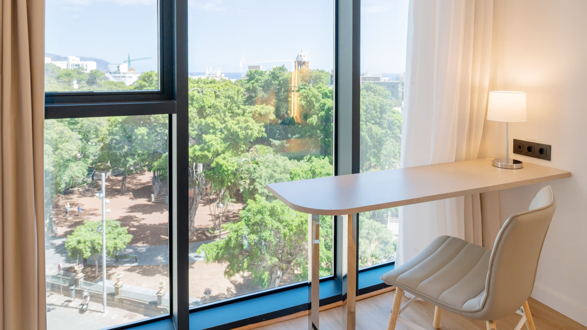 a desk and chair next to a window