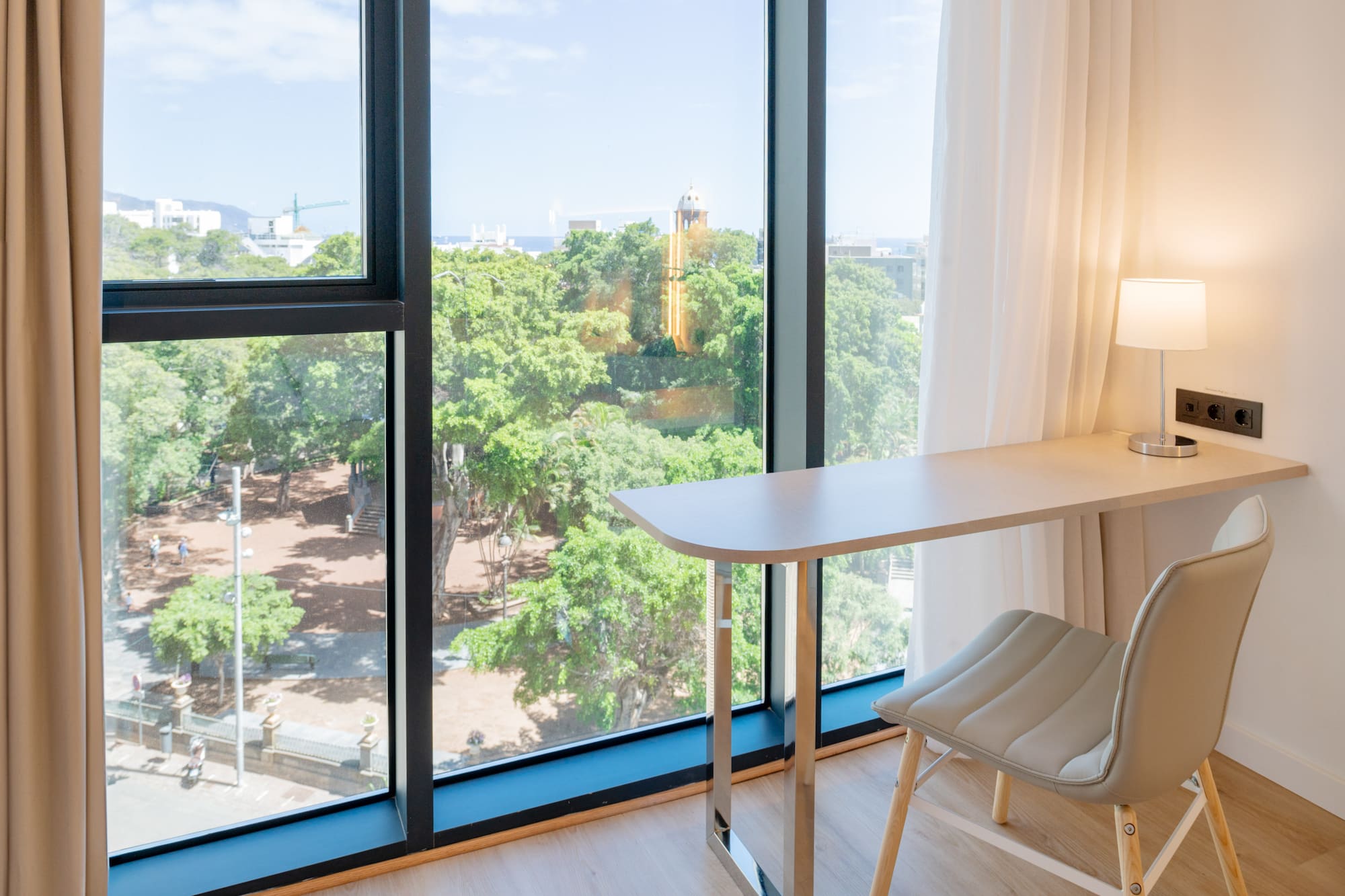 a desk and chair next to a window