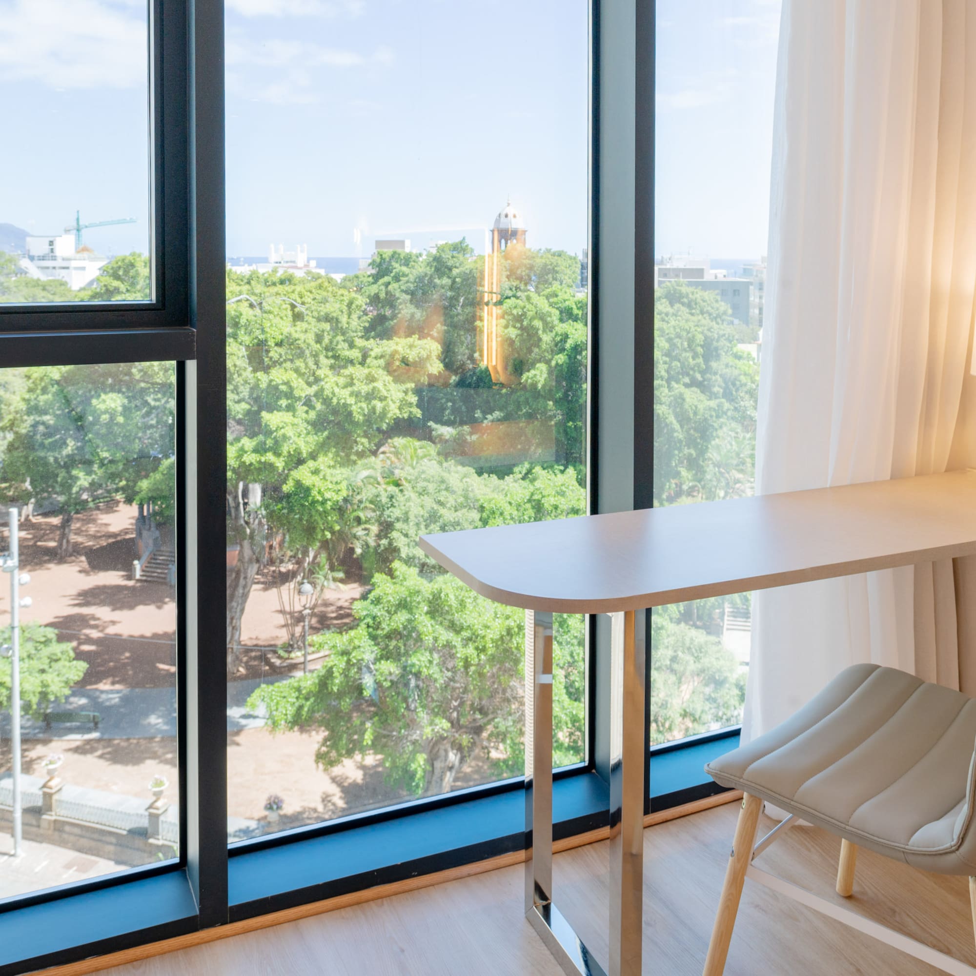 a desk and chair next to a window