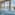 Indoor hydrotherapy spa pool with ocean view, water jets, and waterfall.